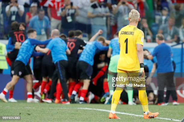 Kasper Schmeichel of Denmark national team walks by as Croatia national team players celebrate victory in background during the 2018 FIFA World Cup...