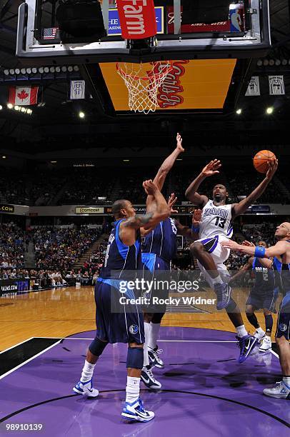 Tyreke Evans of the Sacramento Kings drives to the basket for a layup against Erick Dampier, Jason Kidd and Caron Butler of the Dallas Mavericks...