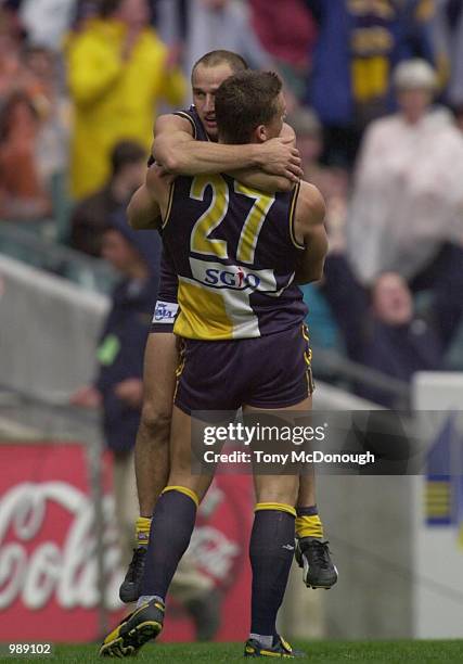 Glen Jakovich hugs Phillip Matera of West Coast Eagles during round 13 AFL match between the West Coast Eagles and Melbourne held at Subiaco in...