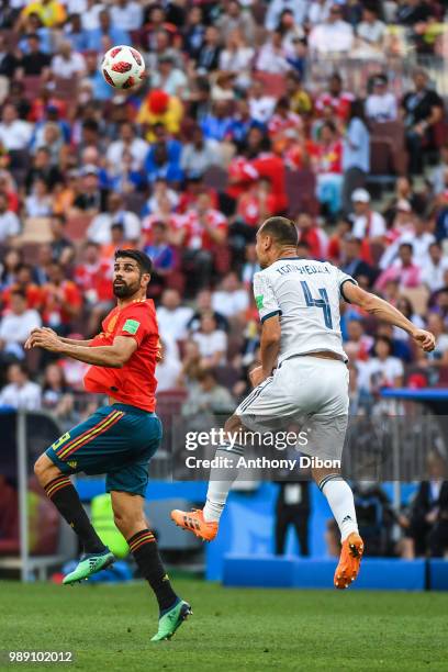 Diego Costa of Spain and Sergey Ignashevich of Russia during the FIFA World Cup Round of 26 match between Spain and Russia at Luzhniki Stadium on...