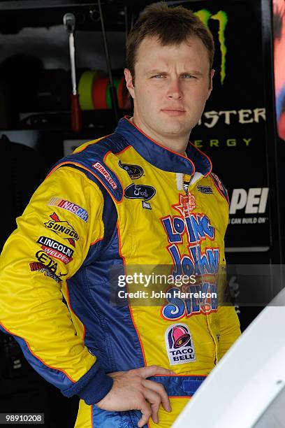 Travis Kvapil, driver of the A&W All American Foods Ford, stands in the garage during practice for the SHOWTIME Southern 500 at Darlington Raceway at...