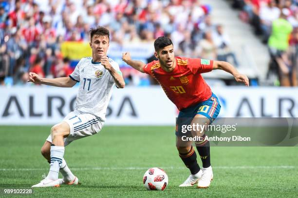 Aleksandr Golovin of Russia and Marco Asensio of Spain during the FIFA World Cup Round of 26 match between Spain and Russia at Luzhniki Stadium on...