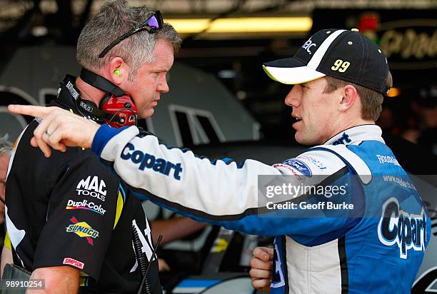 Carl Edwards , driver of the Aflac Ford, talks with crew chief Bob Osborne in the garage during practice for the NASCAR Sprint Cup Series SHOWTIME...