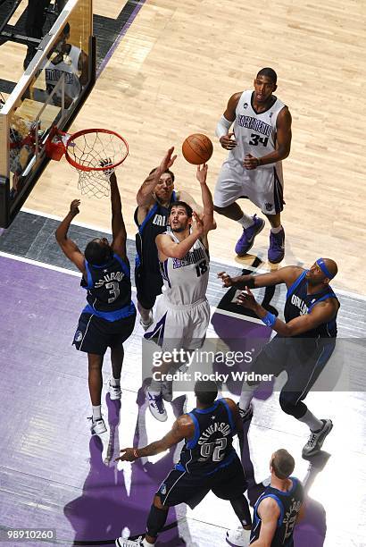 Omri Casspi of the Sacramento Kings shoots a layup against Eduardo Najera, Rodrigue Beaubois, Erick Dampier and DeShawn Stevenson of the Dallas...