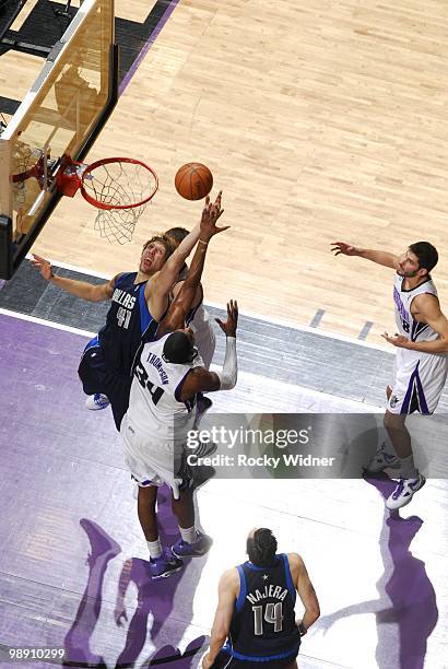 Dirk Nowitzki of the Dallas Mavericks rebounds against Jason Thompson of the Sacramento Kings during the game at Arco Arena on April 10, 2010 in...