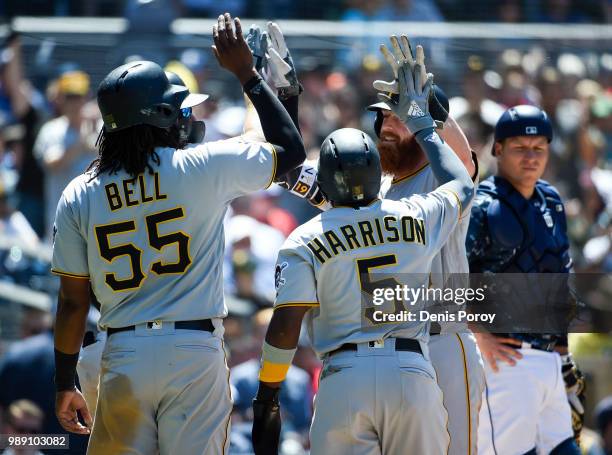 Colin Moran of the Pittsburgh Pirates, right, is congratulated by Josh Bell and Josh Harrison after hitting a grand slam during the fifth inning of a...