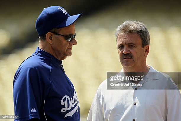 Los Angeles Dodgers manager Joe Torre and general manager Ned Colletti talk prior to the start of the game against the San Francisco Giants at Dodger...