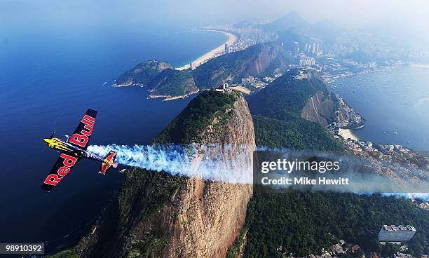 Kirby Chambliss of USA flies high above Sugarloaf Mountain with Copacabana beach in the background during the Red Bull Air Race Training Day at the...