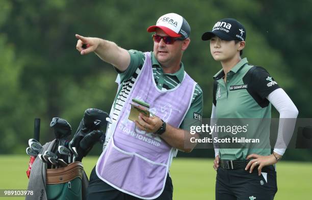 Sung Hyun Park of South Korea lines up a shot with her caddie on the 15th hole during the final round of the KPMG Women's PGA Championship at Kemper...