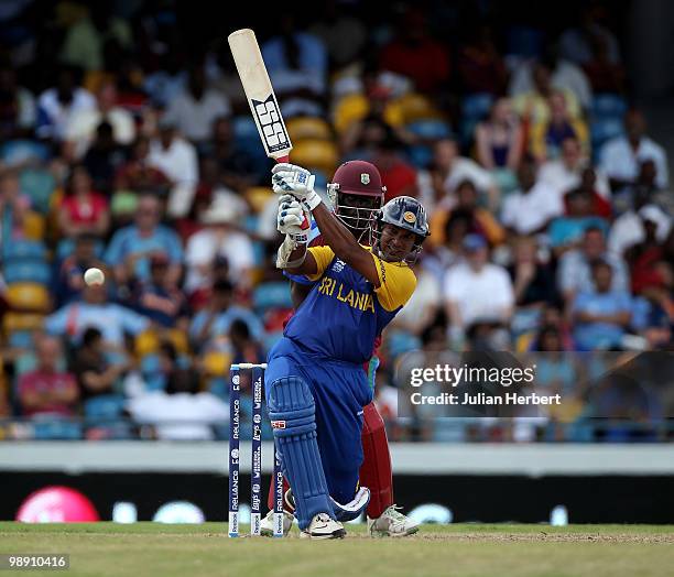 Andre Fletcher of The West Indies looks on as Kumar Sangakkara hits out during The ICC World Twenty20 Super Eight Match between The West Indies and...
