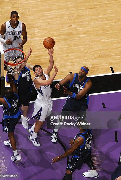 Omri Casspi of the Sacramento Kings shoots a layup against Eduardo Najera, Rodrigue Beaubois, Erick Dampier and DeShawn Stevenson of the Dallas...