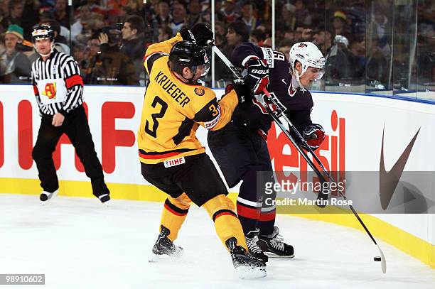 Justin Krueger of Germany and Chris Kreider of USA compete for the puck during the IIHF World Championship group D match between USA and Germany at...