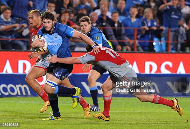 Danie Rossouw of the Bulls is tackled by Dan Carter of the Crusaders during the Super 14 round 13 match between Vodacom Bulls and Crusaders at Loftus...