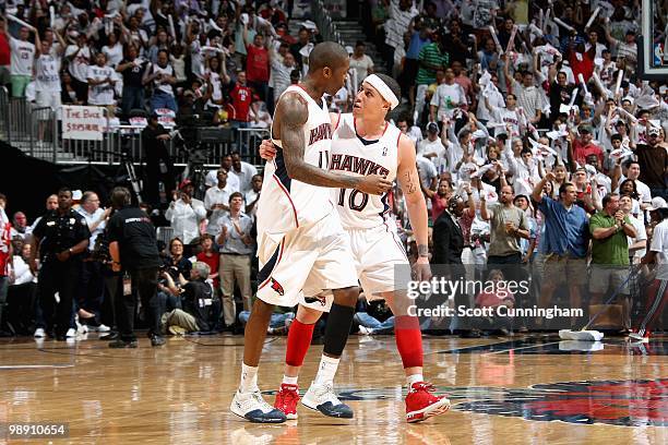 Jamal Crawford and Mike Bibby of the Atlanta Hawks walk across the court in Game Seven of the Eastern Conference Quarterfinals against the Milwaukee...