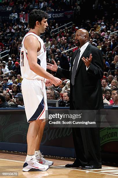 Zaza Pachulia talks to head coach Mike Woodson of the Atlanta Hawks during the game against the Detroit Pistons on March 13, 2010 at Philips Arena in...