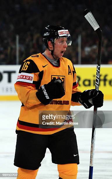 Michael Wolf of Germany celebrates after he scores his team's opening goal during the IIHF World Championship group D match between USA and Germany...
