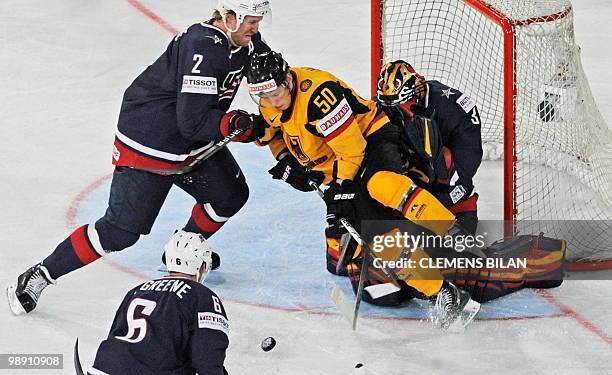 Germany's Patrick Hager vies with USA's Andy Greene , Matt Greene and goalkeeper Jack Johnson during the IIHF Ice Hockey World Championship Gruppe D...