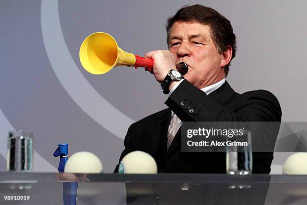 Otto Rehhagel, head coach of the Greece national football team, blows into a vuvuzela during the DFB Live at the Steigenberger Airport hotel on May...