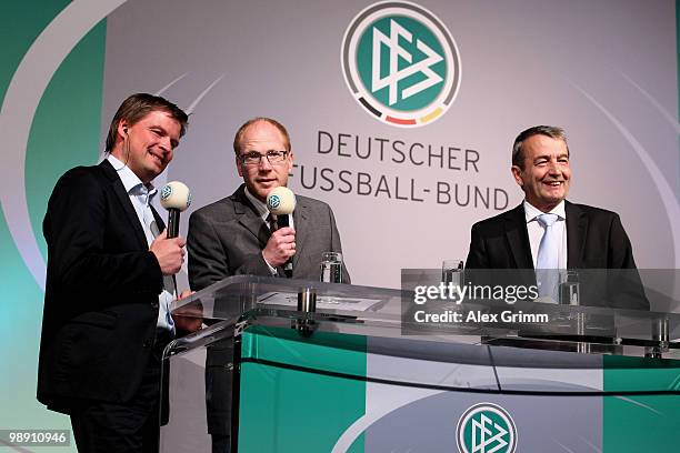 Sport director Matthias Sammer and general secretary Wolfgang Niersbach stand on stage during an interview with Jens Grittner at the DFB Live at the...