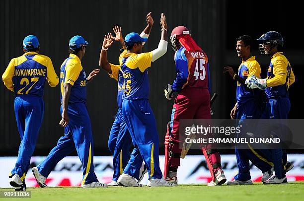 Sri Lankan players celebrate after taking the wicket of West Indies captain Chris Gayle during the ICC World Twenty20 Super Eight match between West...