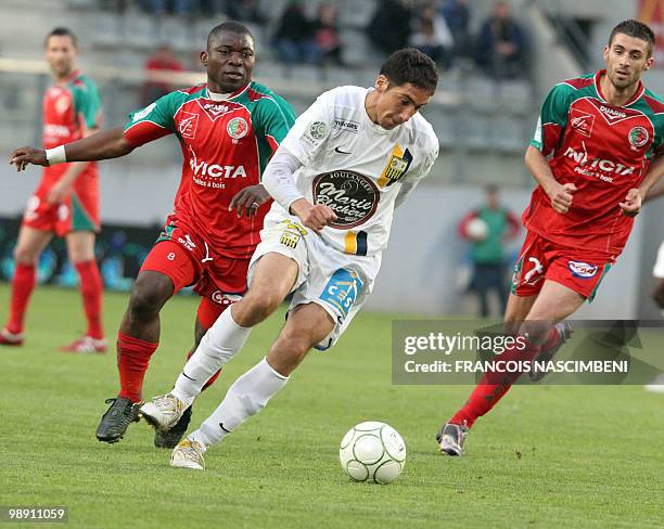 Sedan's forward Markus Mokake vies with Arles-Avignon's midfielder Thomas Ayasse during the French L2 football match Sedan vs. Arles-Avignon, on May...