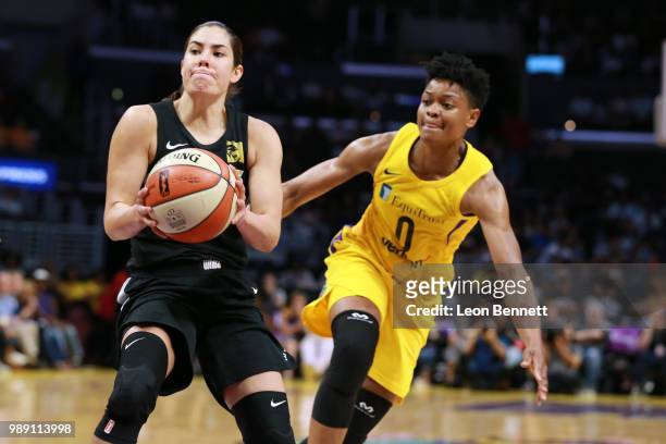 Kelsey Plum of the Las Vegas Aces handles the ball against Alana Beard of the Los Angeles Sparks during a WNBA basketball game at Staples Center on...