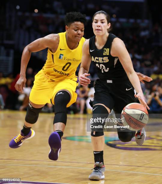 Kelsey Plum of the Las Vegas Aces handles the ball against Alana Beard of the Los Angeles Sparks during a WNBA basketball game at Staples Center on...