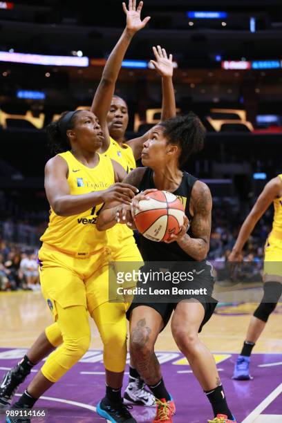 Tamera Young of the Las Vegas Aces handles the ball against Chelsea Gray of the Los Angeles Sparks during a WNBA basketball game at Staples Center on...