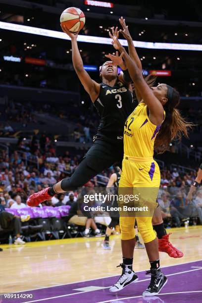 Kelsey Bone of the Las Vegas Aces handles the ball against Jantel Lavender of the Los Angeles Sparks during a WNBA basketball game at Staples Center...