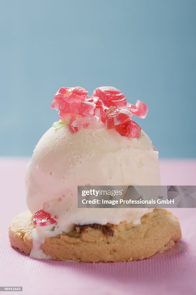 Scoop of ice cream with peppermints on biscuit, close-up