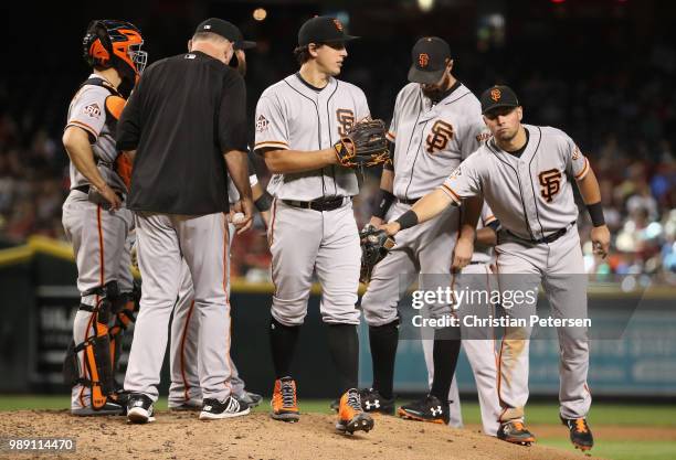 Starting pitcher Derek Holland of the San Francisco Giants is removed by manager Bruce Bochy during fourth inning of the MLB game against the Arizona...