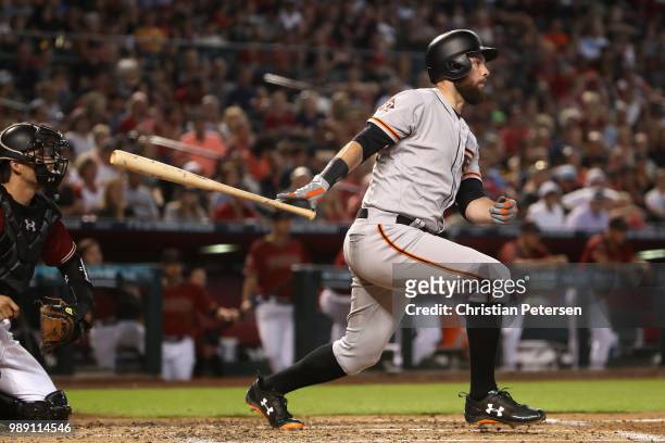 Brandon Belt of the San Francisco Giants hits a RBI double against the Arizona Diamondbacks during the fourth inning of the MLB game at Chase Field...