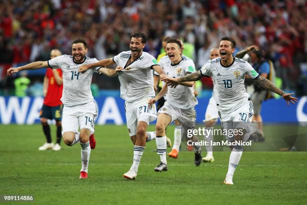 Vladimir Granat , Aleksandr Erokhin, Aleksandr Golovin and Fyodor Smolov of Russia celebrates when they win the penalty shoot out during the 2018...