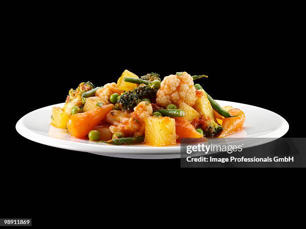 vegetable stew in plate against black background. - vegetable stew stock pictures, royalty-free photos & images