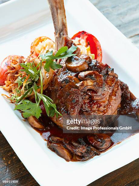 braised lamb with mushroom and red wine sauce in tray. - lamb cutlets bildbanksfoton och bilder