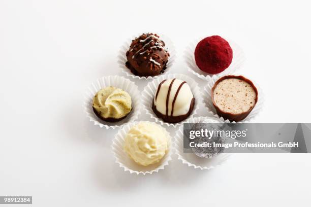 assorted chocolates in paper cases, elevated view - pasticcini foto e immagini stock