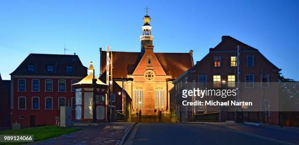 new church illuminated behind new bascule bridge on the red siel, emden, east frisia, lower saxony, germany - bascule bridge stock pictures, royalty-free photos & images
