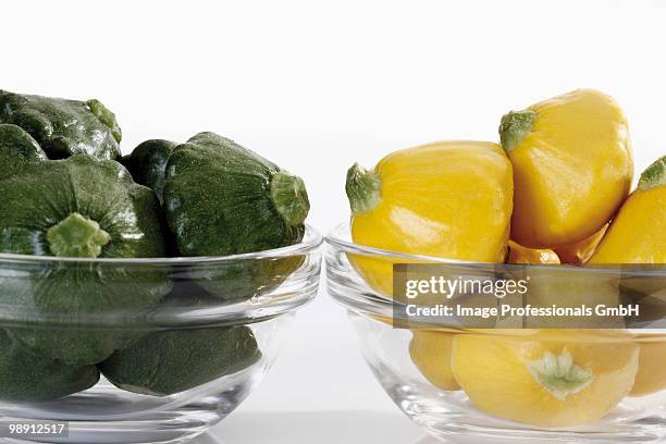 green and yellow patty pan squashes in glass bowls, close-up - pattypan squash stock pictures, royalty-free photos & images