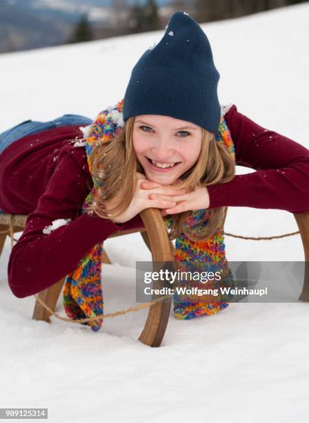 young woman, 20 years, with a sled in the snow - 18 19 years stock pictures, royalty-free photos & images