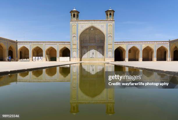 reflection of vakil mosque on a pond, shiraz, iran - emam khomeini square stock pictures, royalty-free photos & images