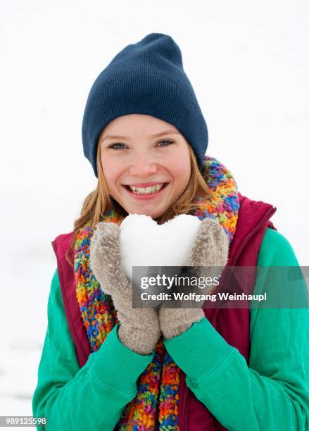 young woman, 22 years, holding a heart made of snow - 18 19 years stock pictures, royalty-free photos & images