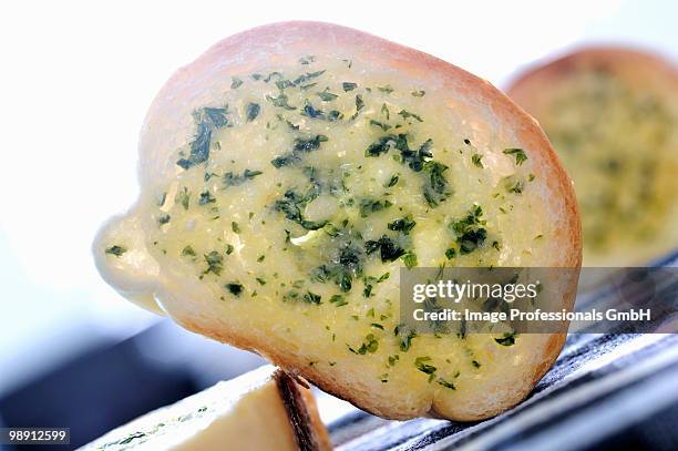 slice of baguette with herb butter, close-up - herb butter stock pictures, royalty-free photos & images