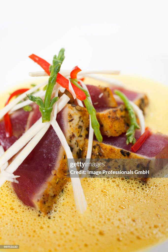 Slice of tuna with lobster curry sauce, close-up