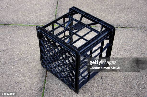 black plastic milk crate on a concrete sidewalk - black milk australia stock pictures, royalty-free photos & images