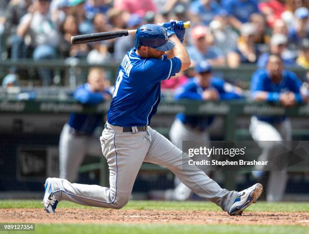 Drew Butera of the Kansas City Royals goes to his knee while swinging at a pitch by starter James Paxton of the Seattle Mariners during the eighth...