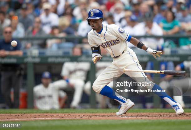 Dee Gordon of the Seattle Mariners lays down a bunt during the sixth inning a game at Safeco Field on July 1, 2018 in Seattle, Washington. The...