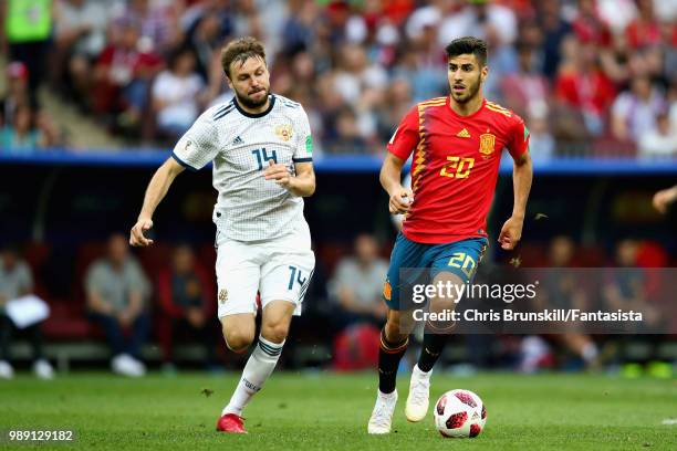 Marco Asensio of Spain is chased down by Vladimir Granat of Russia during the 2018 FIFA World Cup Russia Round of 16 match between Spain and Russia...