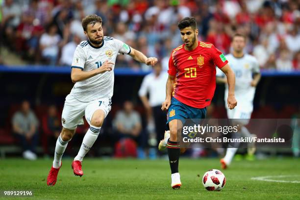 Marco Asensio of Spain is chased down by Vladimir Granat of Russia during the 2018 FIFA World Cup Russia Round of 16 match between Spain and Russia...