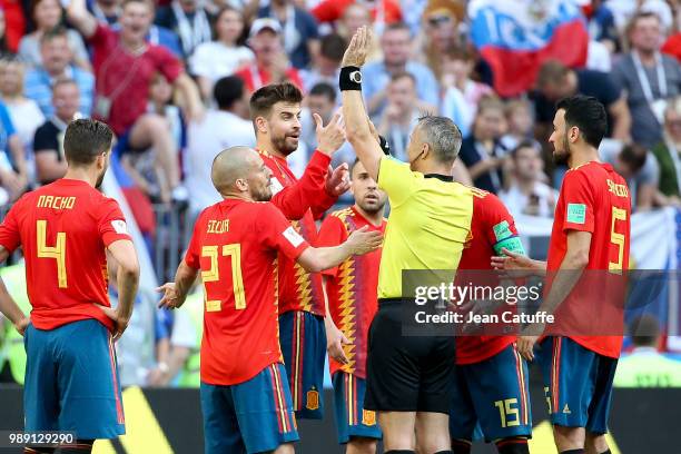 David Silva, Gerard Pique of Spain argue for the penalty with referee Bjorn Kuipers of the Netherlands during the 2018 FIFA World Cup Russia Round of...