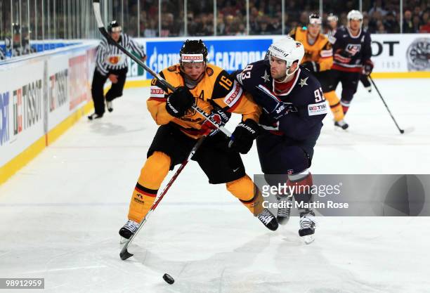 Michael Wolf of Germany and Keith Yandle of USA compete for the puck during the IIHF World Championship group D match between USA and Germany at...